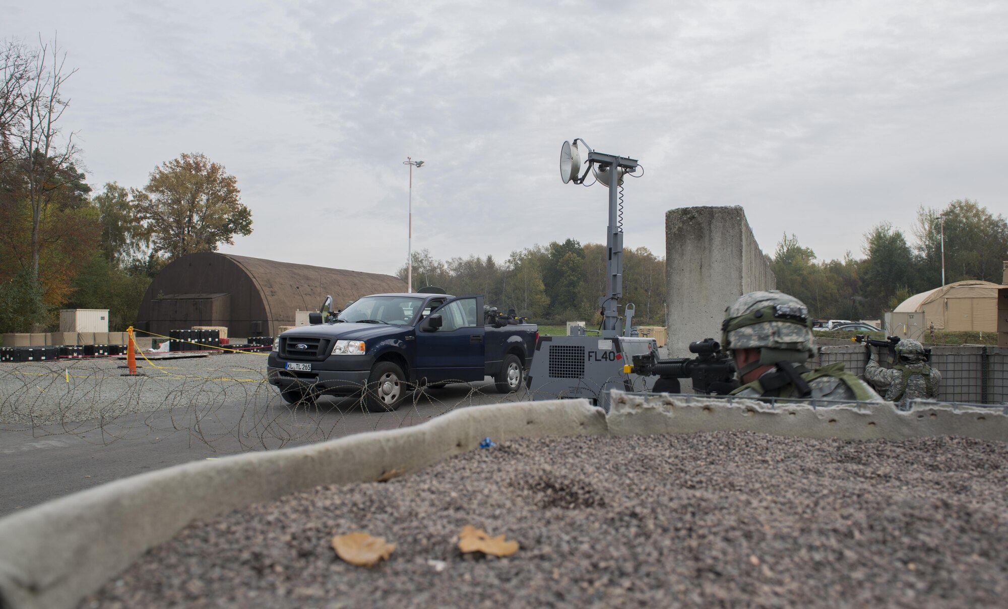 Airmen assigned to the 1st Combat Communications Squadron defend their base against a simulated attack by opposing forces during exercise Healthy Thunder at Ramstein Air Base, Germany, Nov. 4, 2016. In order to make the exercise as real-world as possible, the 1st CBCS used smoke grenades, ground burst simulators and blank rounds. (U.S. Air Force photo by Senior Airman Tryphena Mayhugh)