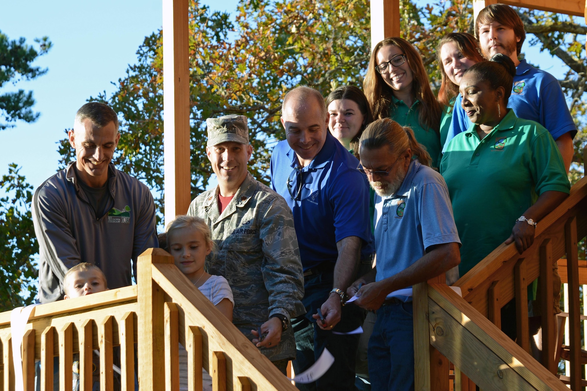 U.S. Air Force Col. Daniel Lasica, 20th Fighter Wing commander, cuts a ribbon with Team Shaw members during the grand opening ceremony for two new cabins at Wateree Recreation Area near Camden, S.C., Nov. 4, 2016. The two new cabins can each host up to eight people and were available to rent as of Nov. 4. (U.S. Air Force photo by Airman 1st Class Kathryn R.C. Reaves)