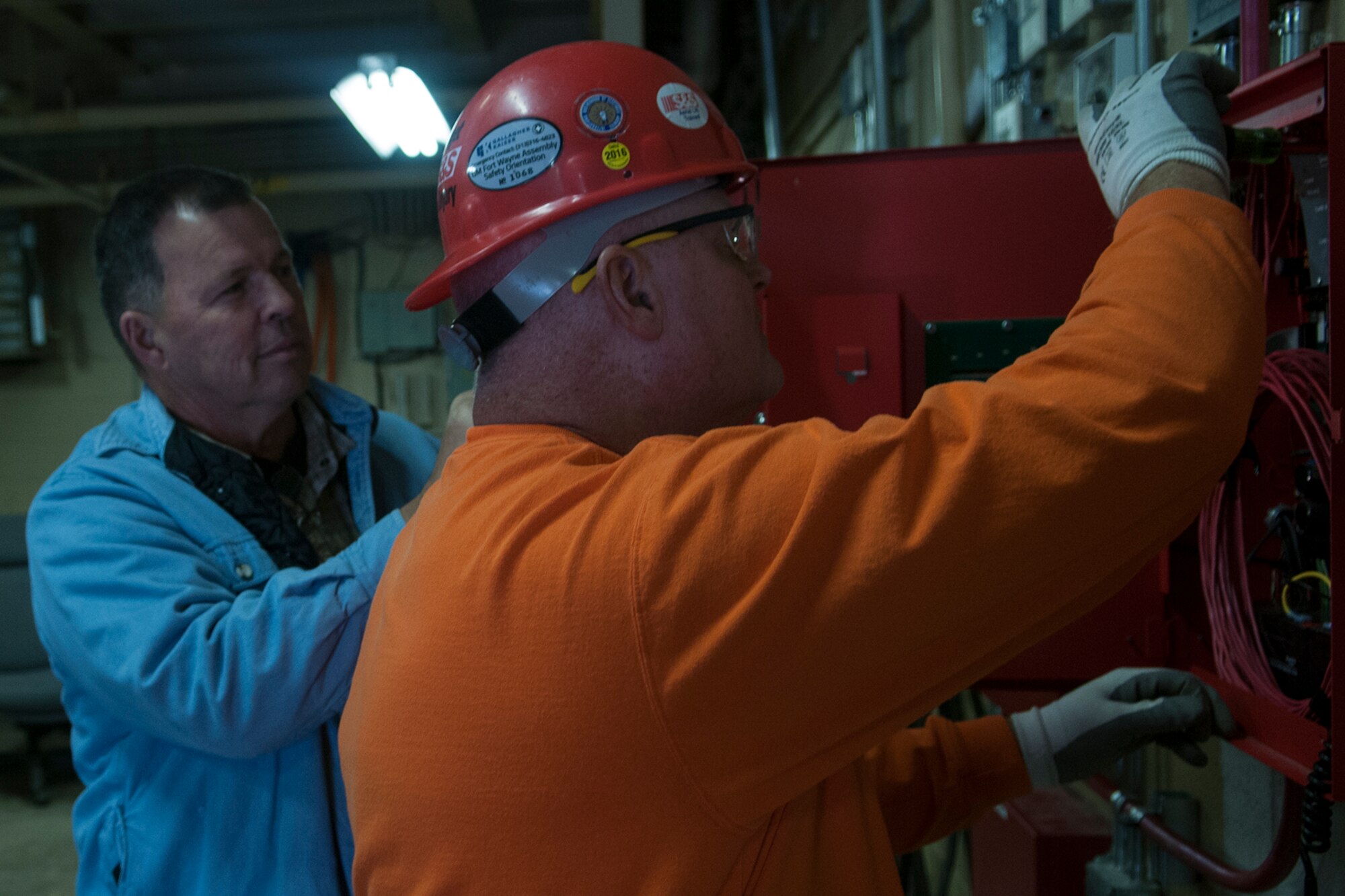 Tommy Patton, 434th Mission Support Group construction engineering technician, inspects Cregg Roush’s, journeyman wireman, work on a fire suppression system panel on October 25, 2016 at Grissom Air Reserve Base, Ind. Employees of Grissom’s contracting office are required to inspect the jobsites they supervise at least once a day. (U.S. Air Force photo/Staff Sgt. Dakota Bergl) 