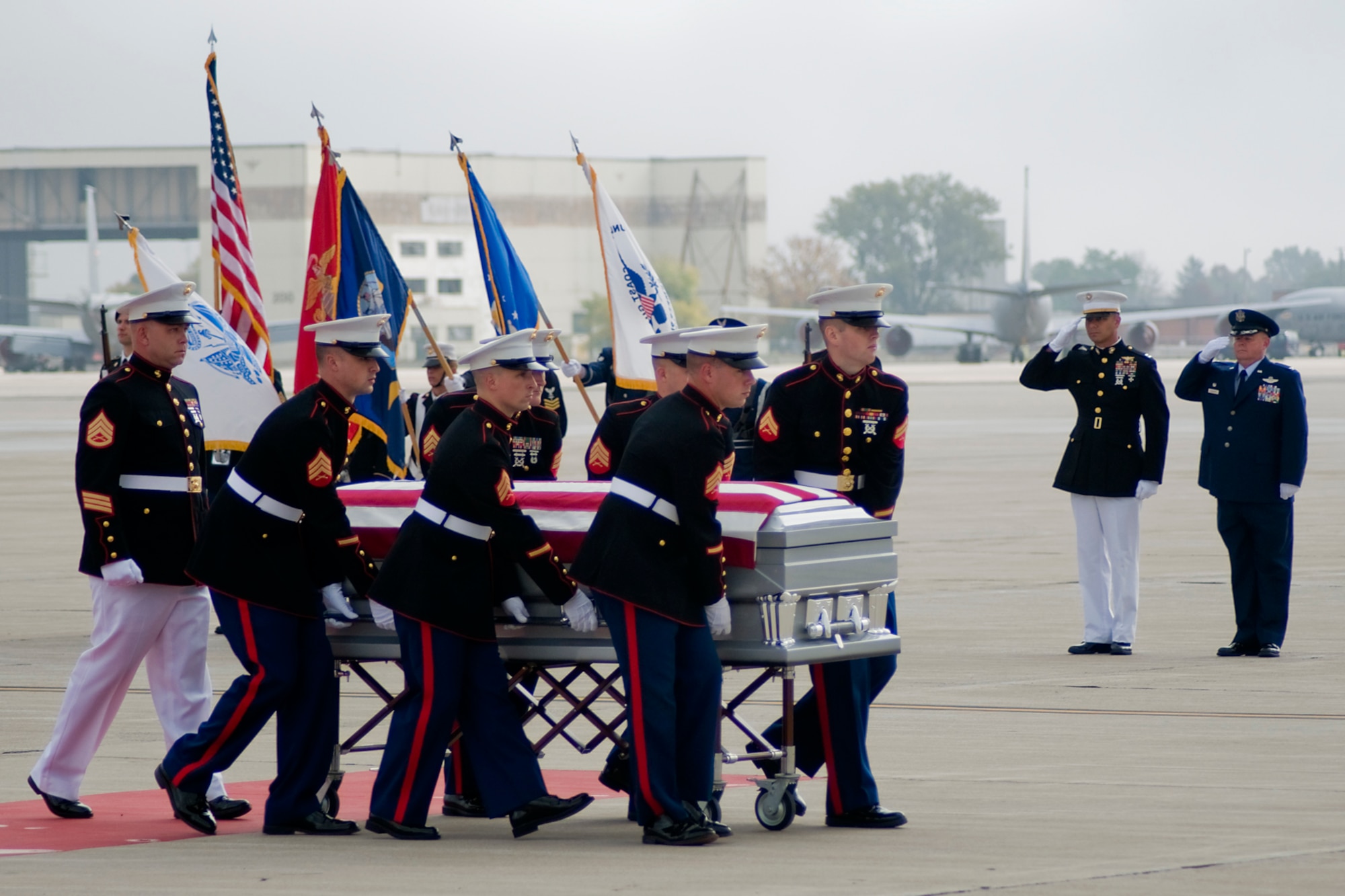 GRISSOM AIR RESERVE BASE, Ind. -- Grissom Marines transfer the remains of Sgt. Bradley Atwell to a nearby hearse as a joint color guard, Capt. Mark Trouerbach and Col. Don Buckley pay their respects by saluting Sept. 28. Atwell, a Hoosier Marine, lost his life Sept. 15 while supporting combat operations at Camp Bastion in Helmand Province, Afghanistan. Buckley is the 434th Air Refueling Wing commander. Trouerbach and the Marine honor guard are assigned to Detachment 1 Communications Company, Headquarters and Service Battalion, 4th Marine Logistics Group. (U.S. Air Force photo/Tech. Sgt. Mark R. W. Orders-Woempner)

