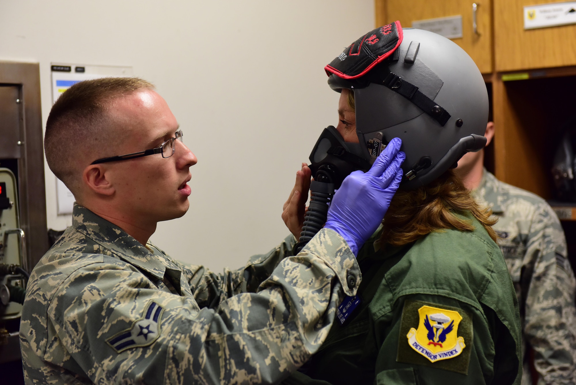 U.S. Air Force Airman 1st Class Jeremy Becker, left, an aircrew flight equipment technician with the 509th Operations Support Squadron fits an MBU-20/P soft shell mask onto Secretary of the Air Force Deborah Lee James at Whiteman Air Force Base, Mo., Nov. 8, 2016. During James’ visit to Whiteman, she learned more about the 509th Bomb Wing’s role in strategic deterrence, held an all call, and flew in a B-2 Spirit. (U.S. Air Force photo by Senior Airman Joel Pfiester)