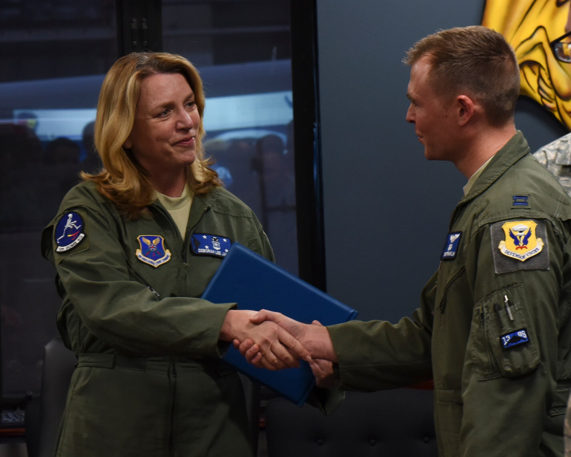 Secretary of the Air Force Deborah Lee James shakes, left, hands with U.S. Air Force Capt. Zachary Franklin, a B-2 Spirit pilot assigned to the 13th Bomb Squadron, after her B-2 Spirit flight debrief at Whiteman Air Force Base, Mo., Nov. 8, 2016. James had the opportunity to fly with Franklin during her B-2 flight. (U.S. Air Force photo by Senior Airman Danielle Quilla)