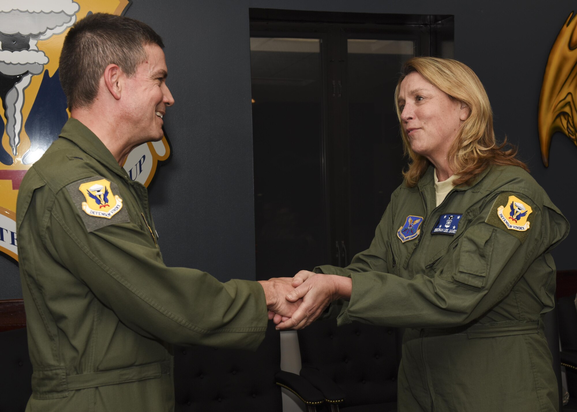 Secretary of the Air Force Deborah Lee James, right, receives a spirit coin from U.S. Air Force Brig. Gen. Paul W. Tibbets IV, the 509th Bomb Wing commander, at Whiteman Air Force Base, Mo., Nov. 8, 2016. During her post flight debrief, James observed first-hand the team work involved in ensuring each B-2 Spirit mission is conducted safely and successfully. (U.S. Air Force photo by Senior Airman Danielle Quilla)