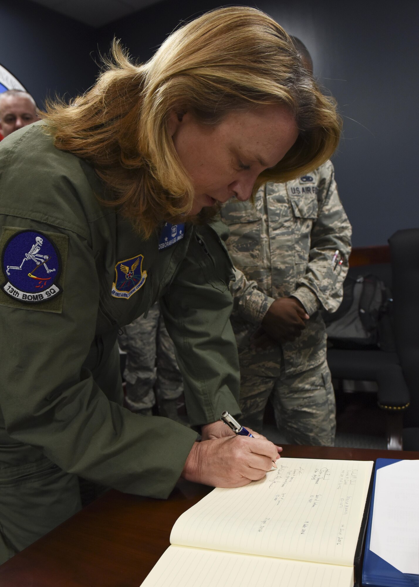 Secretary of the Air Force Deborah Lee James signs a B-2 Spirit log following her flight in a B-2 stealth bomber at Whiteman Air Force Base, Mo., Nov. 8, 2016. James had the opportunity to fly in a stealth bomber during her visit to Whiteman and see first-hand Whiteman’s strategic mission.  (U.S. Air Force photo by Senior Airman Danielle Quilla)