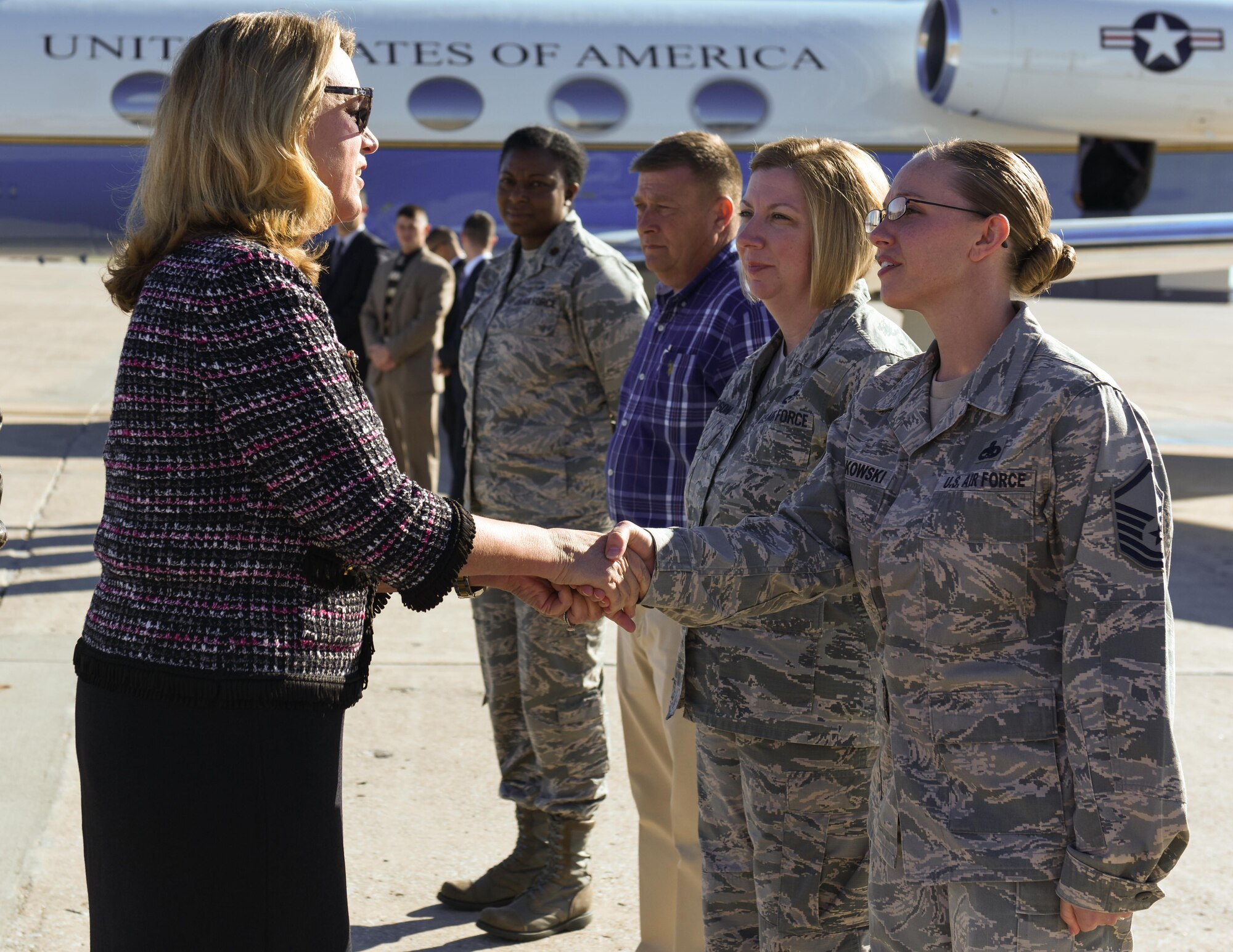 Secretary of the Air Force Deborah Lee James coins members of Team Whiteman who helped organize her visit to Whiteman Air Force Base, Mo., Nov. 9, 2016. James met with Total Force Airmen during her visit to understand how each of the organizations work together to accomplish the overall mission at Whiteman. (U.S. Air Force photo by Senior Airman Danielle Quilla)