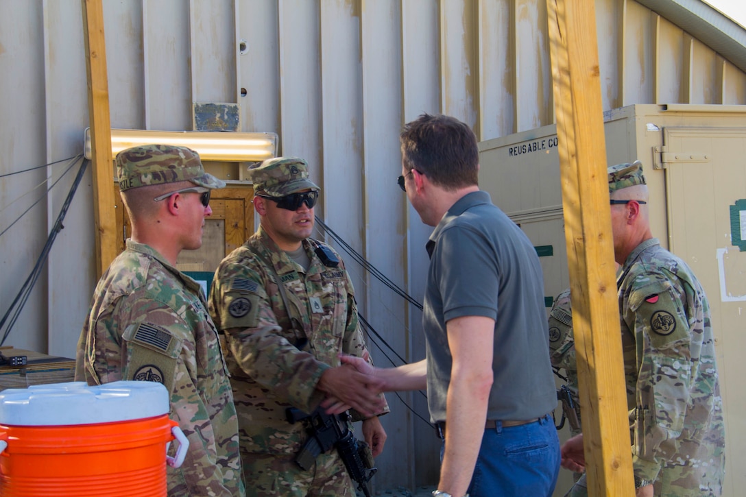 Army Staff Sgt. Nicholas Szyman shakes hands with Army Secretary Eric Fanning during his visit to Train, Advise and Assist Command East in eastern Afghanistan, Sept. 16, 2016. Army photo by Capt. Grace Geiger