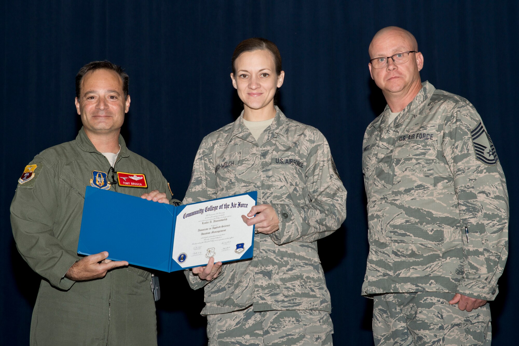 U.S. Air Force Reserve Col. Anthony Brusca, interim commander for the 913th Airlift Group, Tech. Sgt. Leslie Alonso-Welch, aviation resource manager, 327th Airlift Squadron and Chief Master Sgt. Paul Stewart, superintendent, 913 AG, pose for a photo during a Commander’s Call at Little Rock Air Force Base, Ark., Nov. 6, 2016. Alonso-Welch received her Community College of the Air Force Associates Degree in Aviation Management. Colonel Brusca also recognized nine additional Airmen for personal achievements. (U.S. Air Force photo by Master Sgt. Jeff Walston/Released)