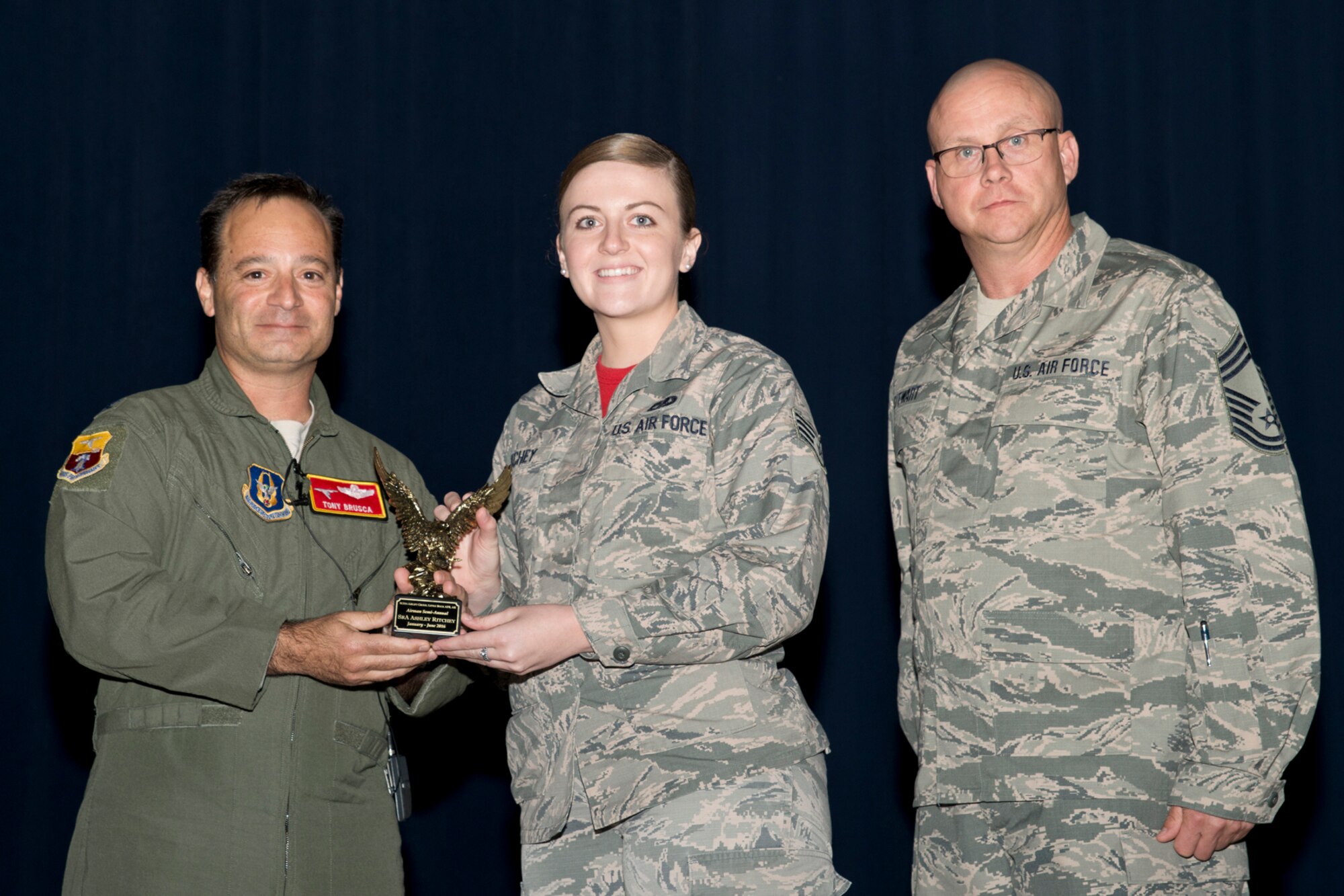 U.S. Air Force Reserve Col. Anthony Brusca, interim commander for the 913th Airlift Group, Senior Airman Ashley Ritchey, 96th Aerial Port Squadron, and Chief Master Sgt. Paul Stewart, superintendent, 913 AG, pose for a photo during Commander’s Call at Little Rock Air Force Base, Ark., Nov. 6, 2016. Ritchey was the 913th Airlift Group’s semi-annual Award Winner in the Airman Category. (U.S. Air Force photo by Master Sgt. Jeff Walston/Released)