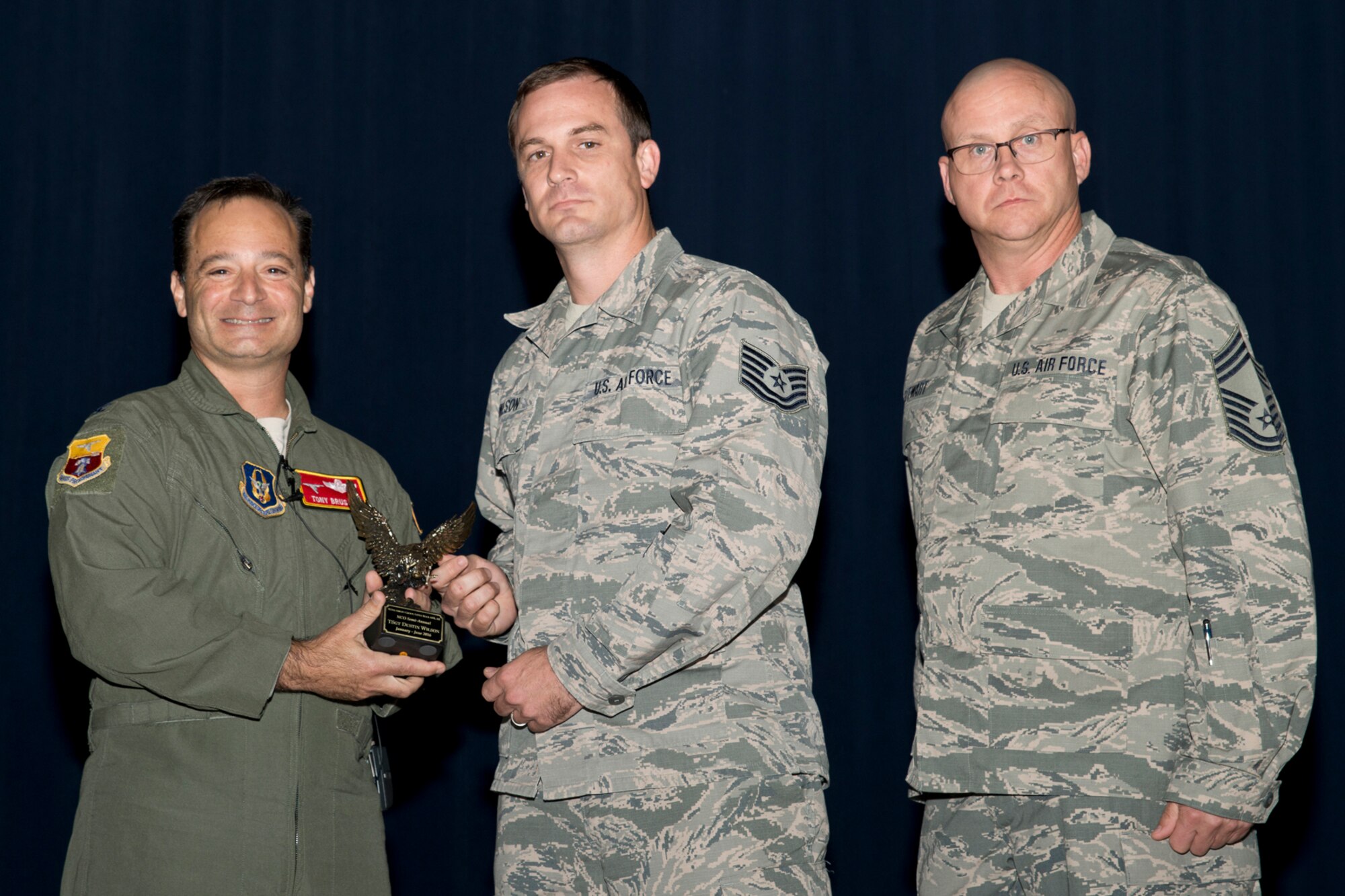 U.S. Air Force Reserve Col. Anthony Brusca, interim commander for the 913th Airlift Group, Tech. Sgt. Dustin Wilson, 96th Aerial Port Squadron, and Chief Master Sgt. Paul Stewart, superintendent, 913 AG, pose for a photo during Commander’s Call at Little Rock Air Force Base, Ark., Nov. 6, 2016. Wilson was the 913th Airlift Group’s semi-annual Award Winner in the Noncommissioned Officer Category. (U.S. Air Force photo by Master Sgt. Jeff Walston/Released)