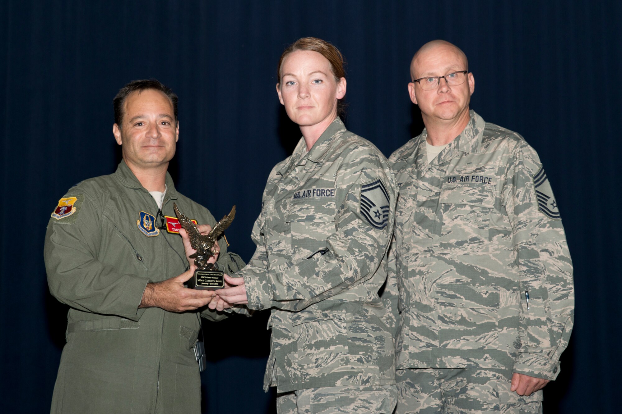 U.S. Air Force Reserve Col. Anthony Brusca, interim commander for the 913th Airlift Group, Senior Master Sgt. Cathryn Rock, 913th Maintenance Squadron, and Chief Master Sgt. Paul Stewart, superintendent, 913 AG, pose for a photo during Commander’s Call at Little Rock Air Force Base, Ark., Nov. 6, 2016. Rock was the 913th Airlift Group’s semi-annual Award Winner in the Senior Noncommissioned Officer Category. (U.S. Air Force photo by Master Sgt. Jeff Walston/Released)