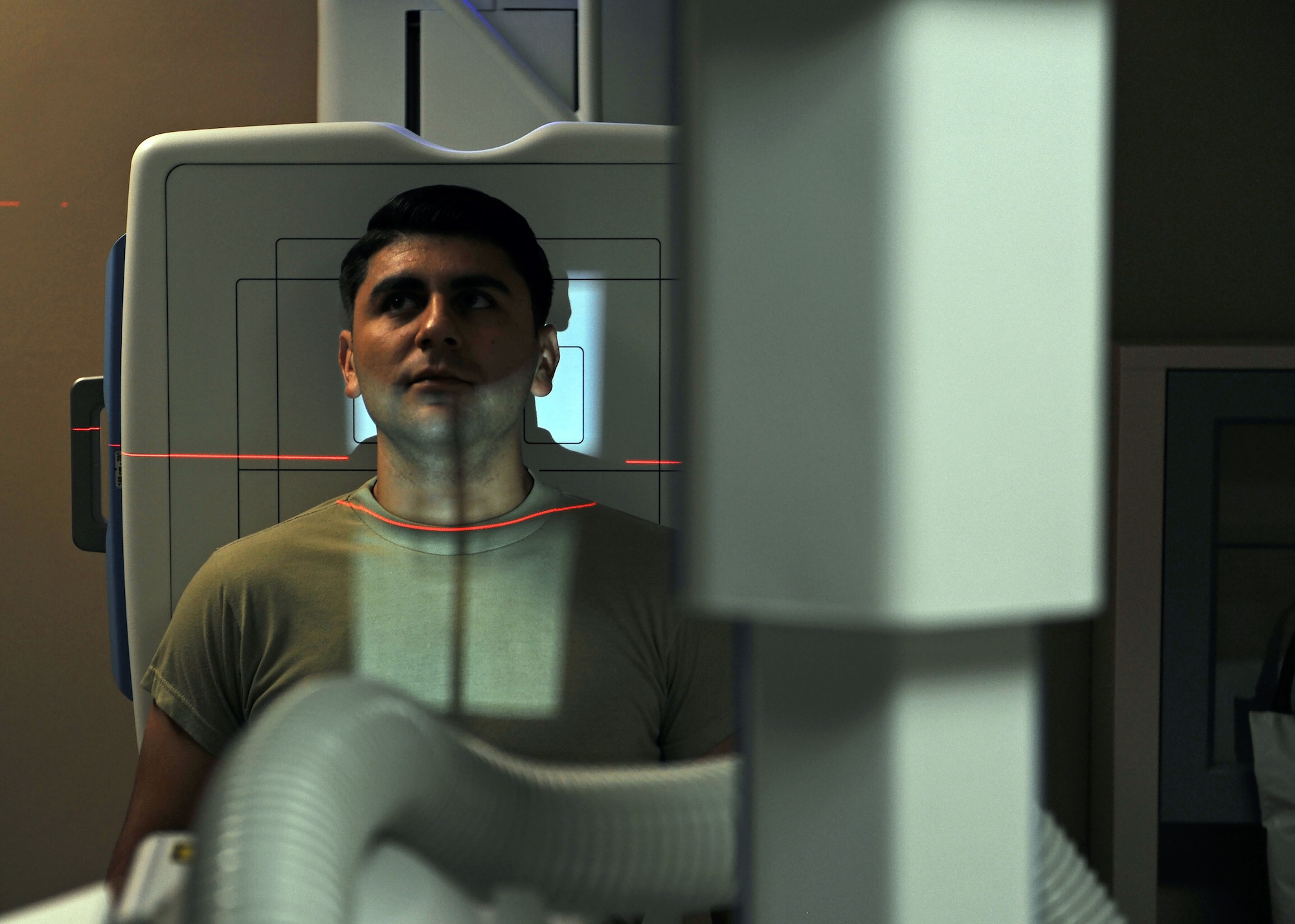 Senior Airman Efren Armenta Herrera, 27th Special Operations Medical Support Squadron diagnostic imaging technologist, simulates having an X-ray taken at 27th Special Operations Medical Group, Oct. 25, 2016. Diagnostic imaging technologists assist physicians by taking comprehensive X-rays of afflicted body parts in settings ranging from surgery centers to imaging rooms. These professionals utilize highly sophisticated equipment and an intimate knowledge of human anatomy to help generate reliable imagery and treat their patients. (U.S. Air Force photo/Staff Sgt. Whitney Amstutz/released)