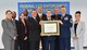 Left to right, Diana Fleming, Emanuel Guerrier, Hillary Zuege, Russel Campbell, Gregory Lynch, Brian Tweed, Col. Garry Little, David Bynum, Chief Master Sgt. Gregory Carmack and Kimberly Caban proudly show the certificate accrediting USAFSIA's online Basic Extension Program with the Federal Law Enforcement Training Accreditation Board Nov. 3. (U.S. Air Force photo/USAFSIA)  