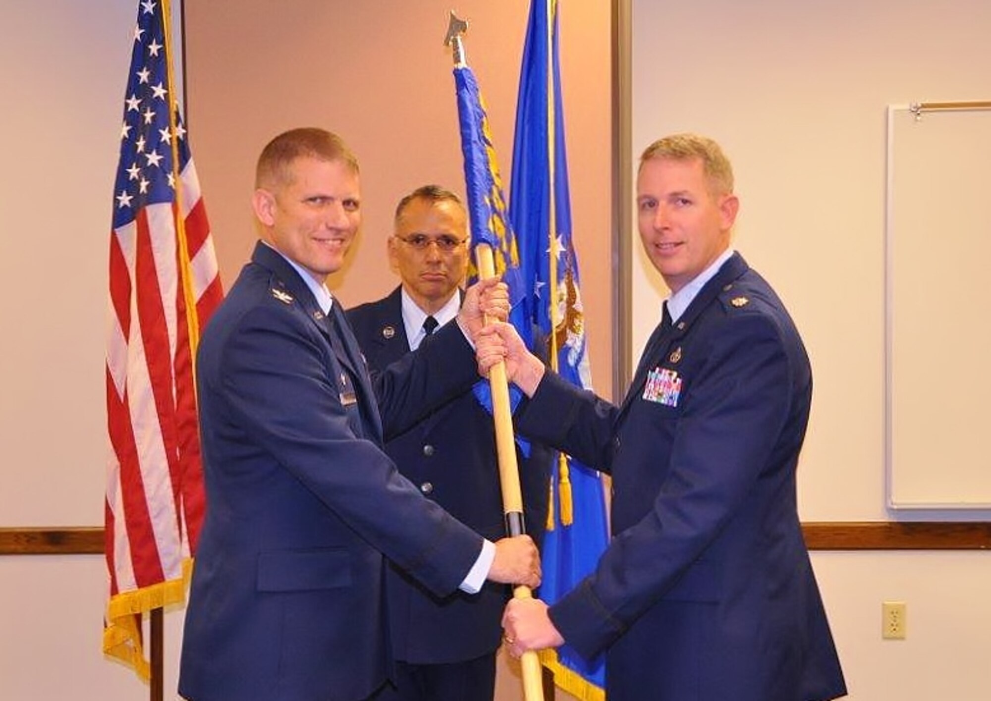 Col. David W. Enfield Jr., left, 433rd Mission Support Group commander, presents the 74th Aerial Port Squadron guidon to  Lt. Col. Travis J. Hatley, the squadron's new commander, during the unit change of command ceremony Nov. 6, 2016 at Joint Base San Antonio-Lackland, Texas. (U.S. Air Force Photo by Capt. Cris Medina)