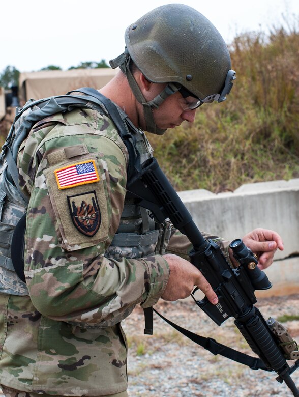 Sgt. Joseph Hall, with the 310th Psychological Operation Company and the U.S. Army Reserve Combat Marksmanship Program, makes a final adjustment on his M4 rifle before starting a event on the third day of the U.S. Army Forces Command Weapons Marksmanship Competition Nov. 9, 2016, at Fort Bragg, N.C. The four-day FORSCOM competition features marksmen from the U.S. Army, U.S. Army Reserve, and the National Guard in events for the M9 pistol, the M4A1 rifle and the M249 SAW, or Squad Automatic Weapon, to recognize Soldiers who are beyond expert marksmen. The multi-tiered events challenge the competitors' ability to accurately and quickly engage targets in a variety of conditions and environments. (U.S. Army photo by Timothy L. Hale/Released)