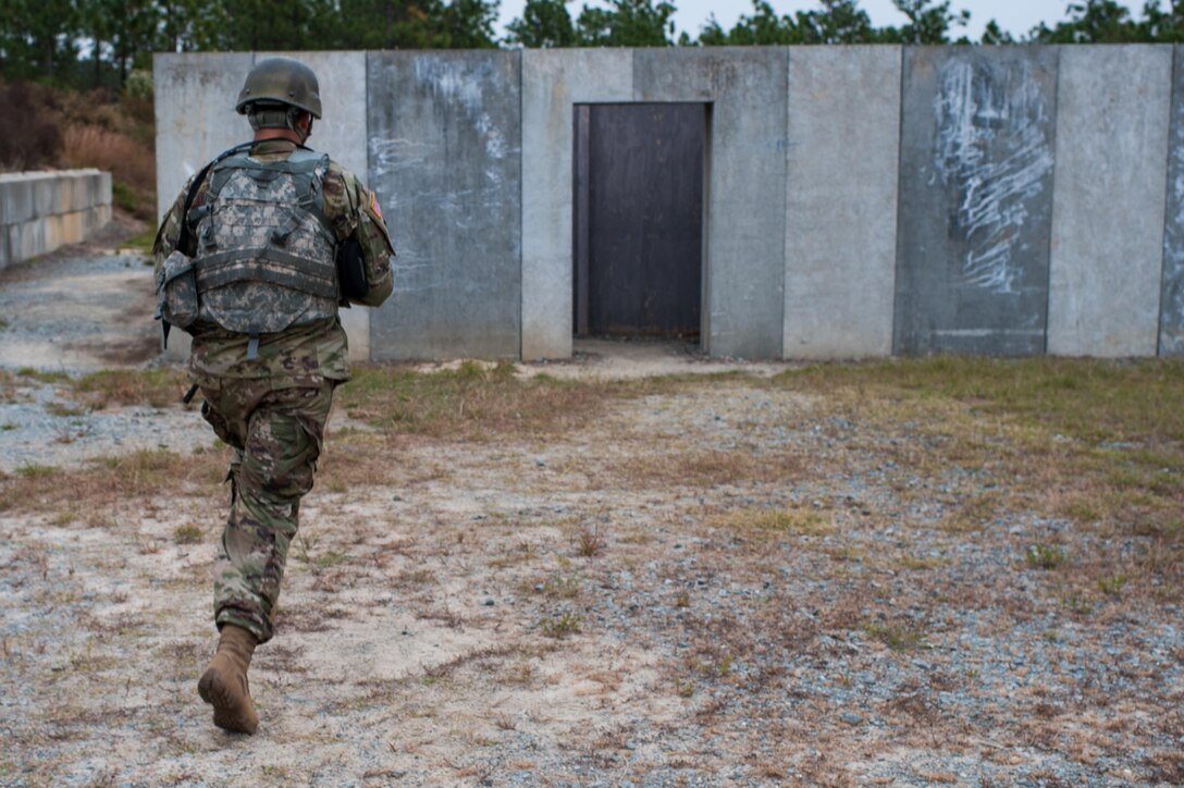 Sgt. Joseph Hall, with the 310th Psychological Operation Company and the U.S. Army Reserve Combat Marksmanship Program, sprints towards a doorway for an event on the third day of the U.S. Army Forces Command Weapons Marksmanship Competition Nov. 9, 2016, at Fort Bragg, N.C. The four-day FORSCOM competition features marksmen from the U.S. Army, U.S. Army Reserve, and the National Guard in events for the M9 pistol, the M4A1 rifle and the M249 SAW, or Squad Automatic Weapon, to recognize Soldiers who are beyond expert marksmen. The multi-tiered events challenge the competitors' ability to accurately and quickly engage targets in a variety of conditions and environments. (U.S. Army photo by Timothy L. Hale/Released)