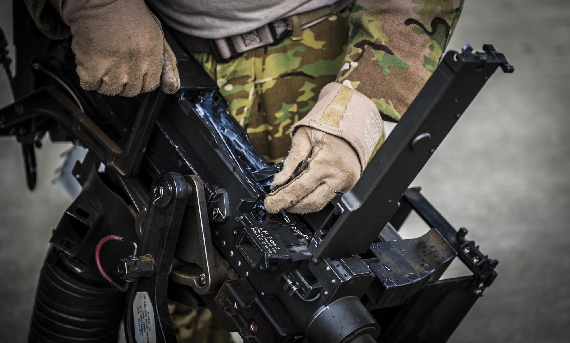 A flight engineer with the 8th Special Operations Squadron checks the bolt of a .50-caliber machine gun at Hurlburt Field, Fla., Nov. 8, 2016. The .50-caliber machine gun weighs more than 80 pounds and is capable of firing up to 850 rounds per minute with a maximum range of approximately 7,400 yards. (U.S. Air Force photo by Airman 1st Class Joseph Pick)