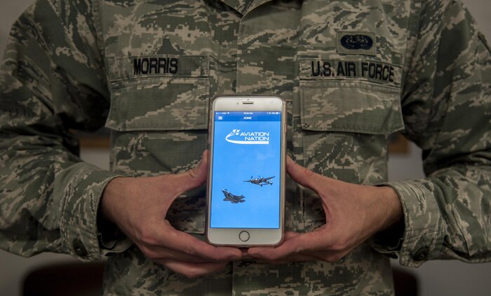 Staff Sgt. Michael Morris, 99th Communications Squadron base content manager, displays the application that he designed for the Aviation Nation Air Show at Nellis Air Force Base, Nev., Nov. 9, 2016. This will be the first year Nellis AFB will have an app available for download specifically for the air show. (U.S. Air Force photo by Airman 1st Class Kevin Tanenbaum/Released)