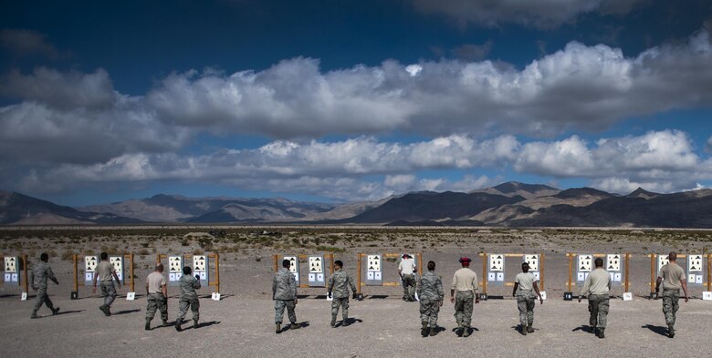 Airmen taking an M4 carbine combat arms training and maintenance class check their targets at Nellis Air Force Base, Nev., Oct. 25, 2016. Once at the range, Airmen are given the opportunity to fire their weapon and familiarize themselves with the tools they will interact with daily while deployed. (U.S. Air Force photo/Airman 1st Class Kevin Tanenbaum)