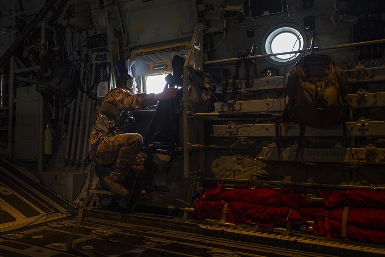 Staff Sgt. Korey King, a 17th Special Operations Squadron loadmaster, looks out the window of an MC-130J during exercise Keen Sword 17, Nov. 7, 2016, near Okinawa, Japan. Exercises like Keen Sword 17 demonstrate the joint capabilities of the U.S and Japan. (U.S. Air Force photo/Senior Airman Stephen G. Eigel)