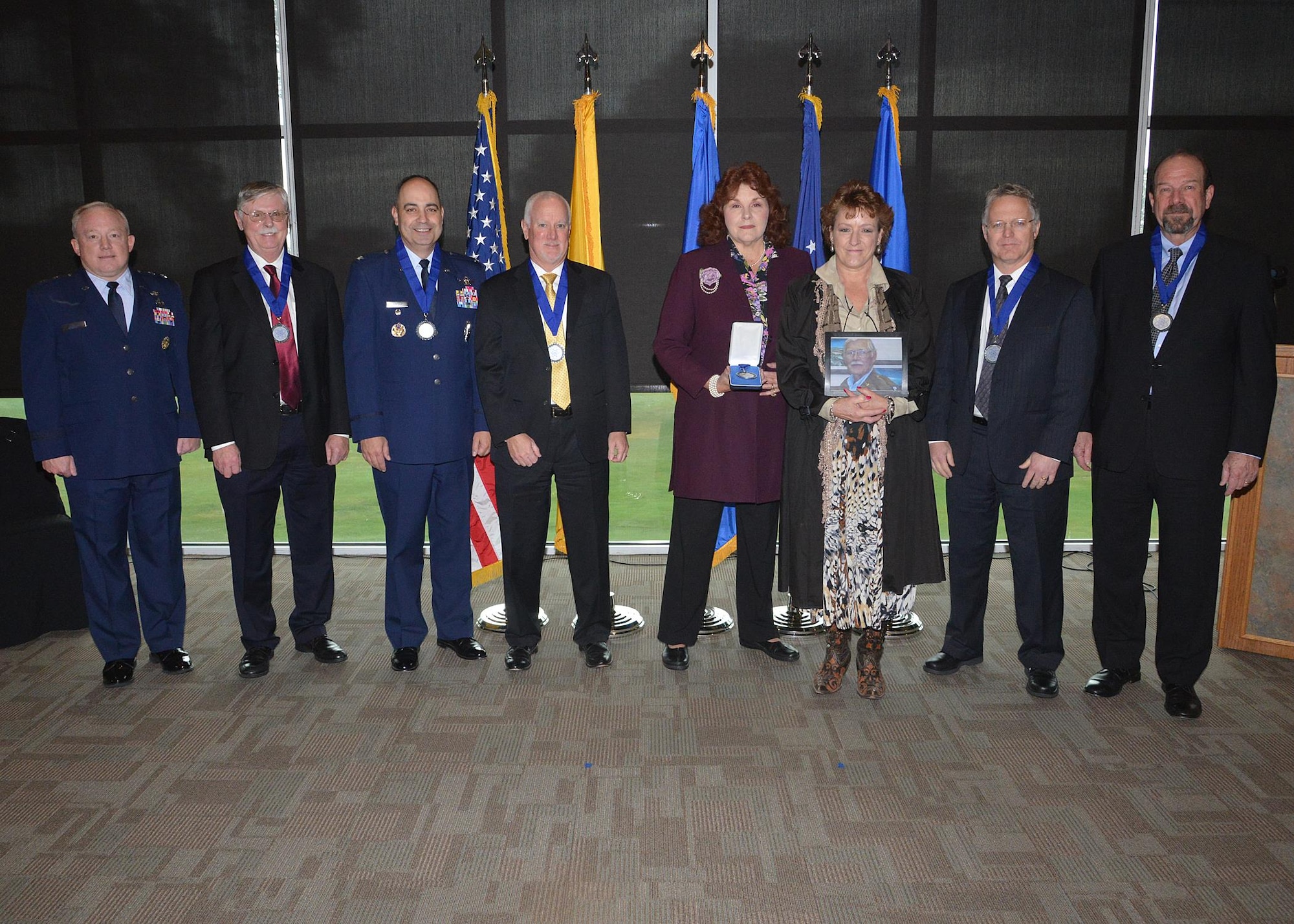 Six individuals were inducted into the Order of the Nucleus at a ceremony at The Canyon Club in Albuquerque, New Mexico, Nov. 4. The Air Force Nuclear Weapons Center established the Order of the Nucleus in 2011 to recognize and honor individuals and groups who have made significant contributions to the nuclear enterprise of the United States. From left are Maj. Gen. Scott W. Jansson, AFNWC commander; Dr. Donald L. Cook; Col. George R. Farfour; Eric N. Single; Eileen Ball and Katrina Benjamin, who accepted on behalf of their father Benjamin C. Benjamin; Jeffrey W. Bean; and James A. Moyers. (U.S. Air Force photo/Todd Berenger)