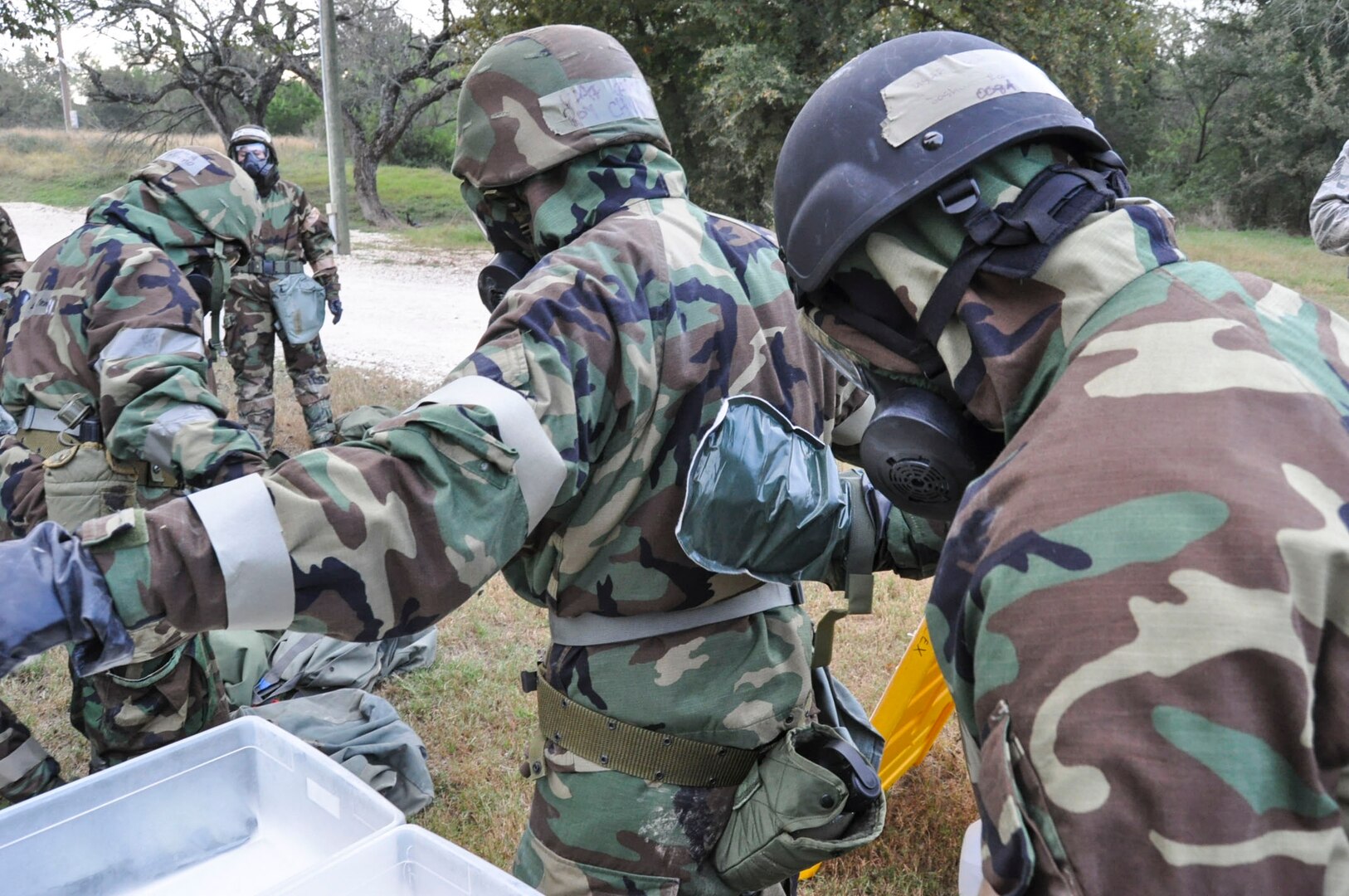 Members of the 433rd Airlift Wing use an M-295 decontamination kit to cleanse one another of any chemical agents at a decontamination checkpoint Nov. 5, 2016 during the Steel Thunder exercise at Joint Base San Antonio-Lackland. Members rely heavily on the buddy system during exercises such as Steel Thunder to ensure maximum protection of assets and military personnel. (U.S. Air Force photo/Senior Airman Bryan Swink)  