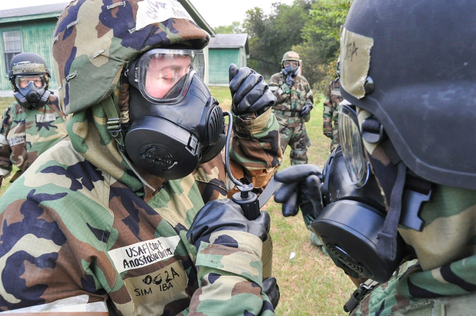 Capt. Anastasia Corker of the 433rd Aeromedical Staging Squadron demonstrates how to drink from a canteen through her gas mask during the Steel Thunder exercise Nov. 5, 2016 at Joint Base San Antonio-Lackland. The exercise is designed to test the unit’s responsiveness to a Chemical, Biological, Radiological, Nuclear and high-yield Explosives attack and its effectiveness while wearing the Mission Oriented Protective Posture gear. (U.S. Air Force photo/Senior Airman Bryan Swink)