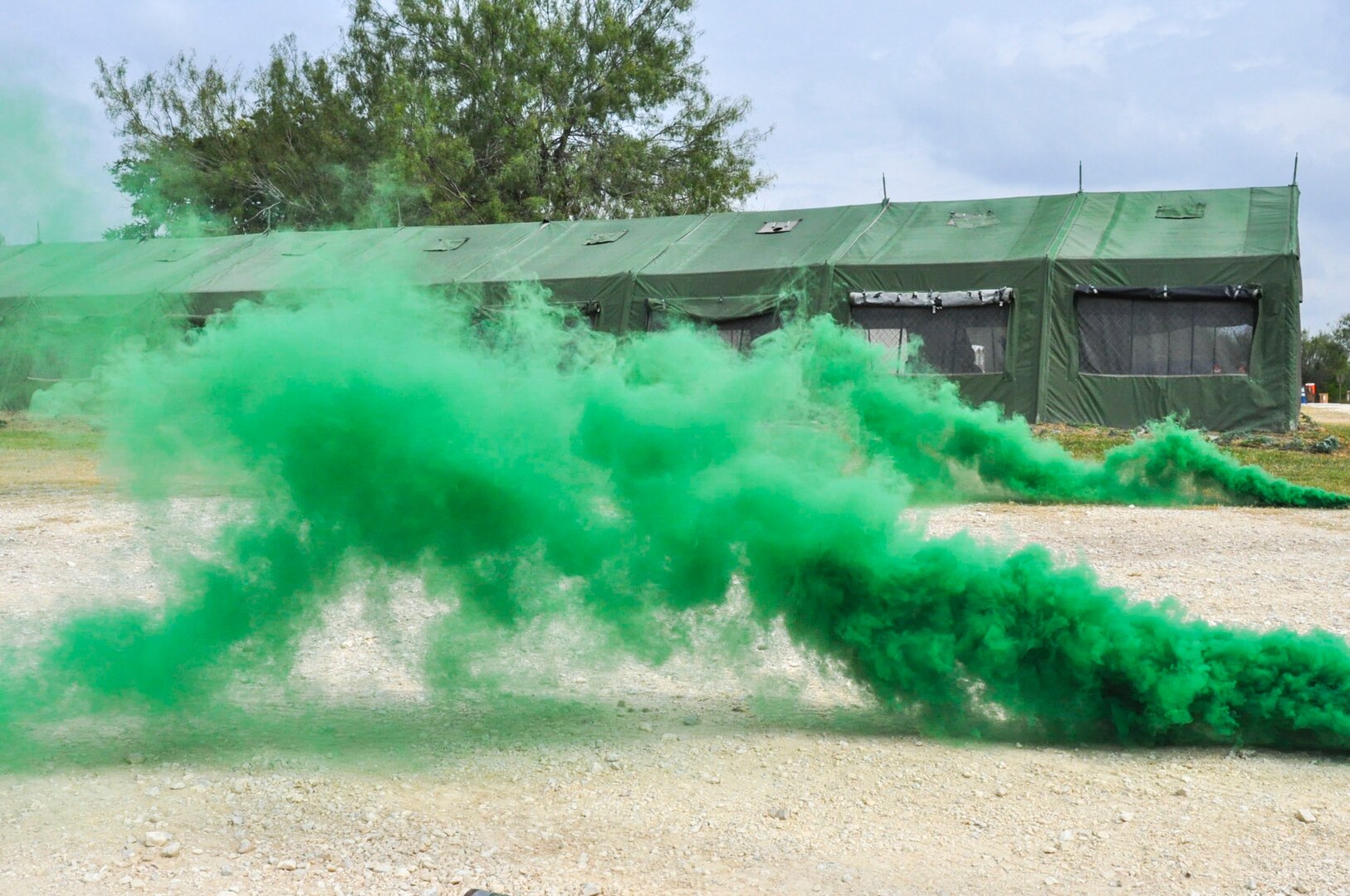 Smoke fills the area surrounding the tent members of the 433rd Airlift Wing are residing in to simulate a chemical attack during the wing's Steel Thunder exercise Nov. 5, 2016 at Joint Base San Antonio-Lackland. The exercise provided Alamo Wing Airmen a chance to don Mission Oriented Protective Posture gear and react to multiple scenarios during a simulated chemical attack. (U.S. Air Force photo/Senior Airman Bryan Swink)