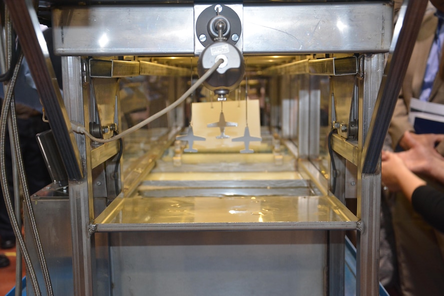 Test specimens are prepared for coating with the Aerocron® 2100 Electrocoat Primer during a recent demonstration at Wright-Patterson Air Force Base.  This water-based, chrome-free primer offers protection comparable to chrome-based coatings, while curing at a lower temperature than conventional automotive and industrial Electrocoats, making it possible to electrocoat aluminum alloys without affecting their physical properties.  (U.S. Air Force photo / David Dixon)