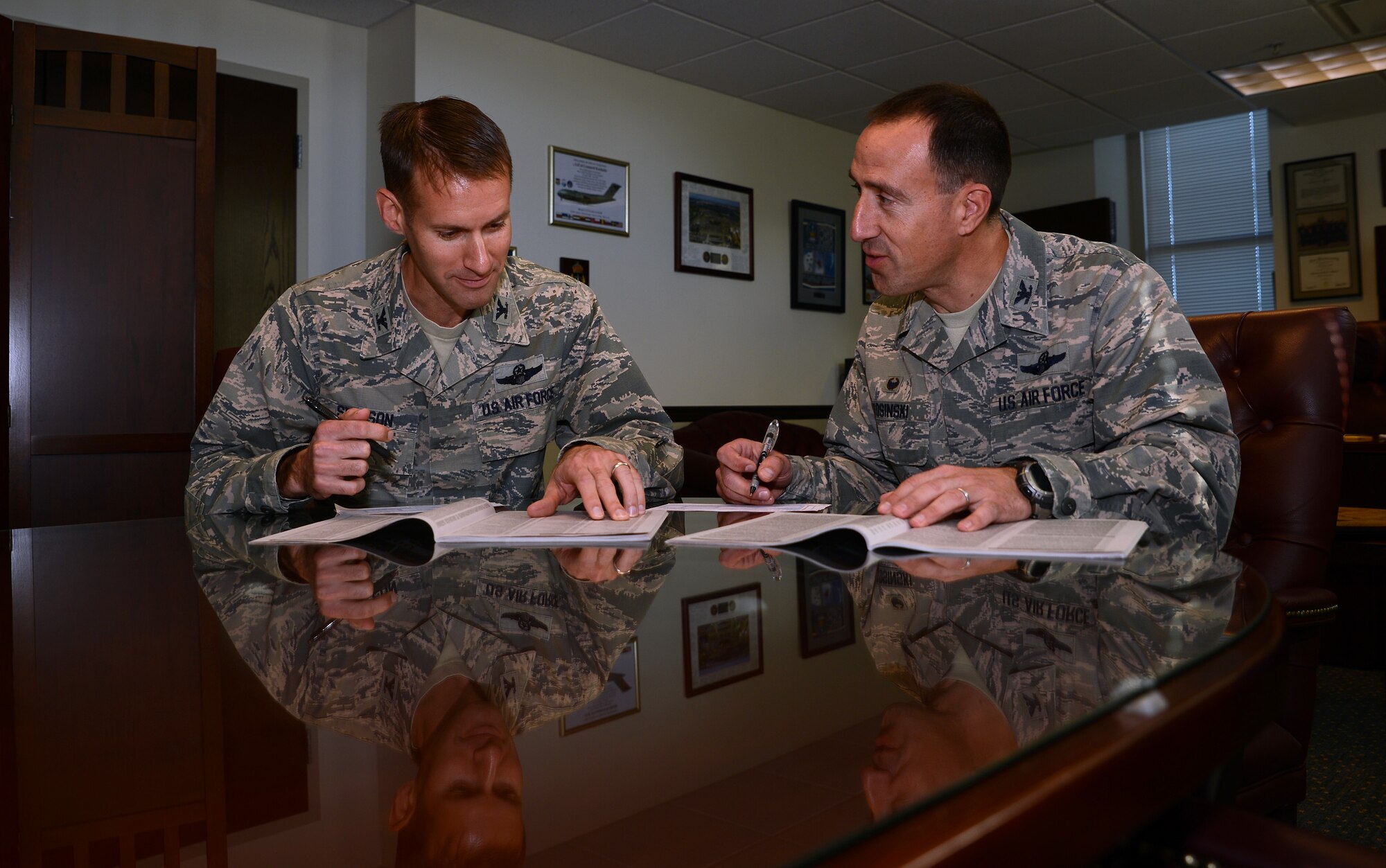 Col. Leonard Kosinski (right), 62nd Airlift Wing commander, and Col. Stephen Snelson, 62nd AW vice commander fill out Combined Federal Campaign pledge forms Nov. 8, 2016, at Joint Base Lewis-McChord, Wash. Team McChord Airmen recently launched this year's CFC drive Oct. 7. (U.S. Air Force photo/Senior Airman Jacob Jimenez)    
