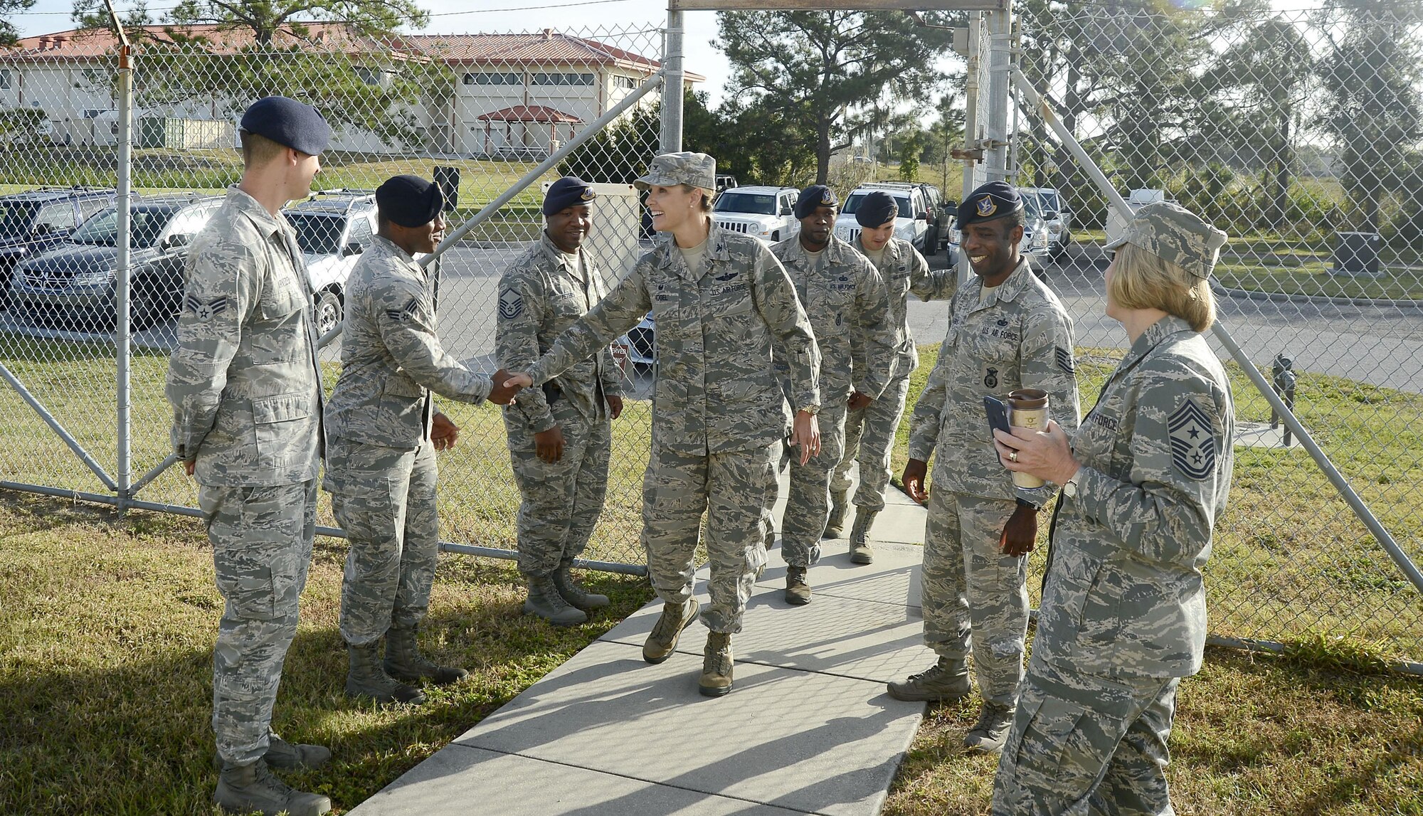 Col. April Vogel, commander of the 6th Air Mobility Wing, greets Airmen assigned to the 6th Security Force Squadron military working dog (MWD) section, during an immersion, Nov. 7, 2016, at MacDill Air Force Base, Fla. While visiting the MWD section, Vogel was briefed on daily tasks, given a tour of the facility and acted as a decoy in a MWD demonstration. (U.S. Air Force photo by Senior Airman Jenay Randolph) 