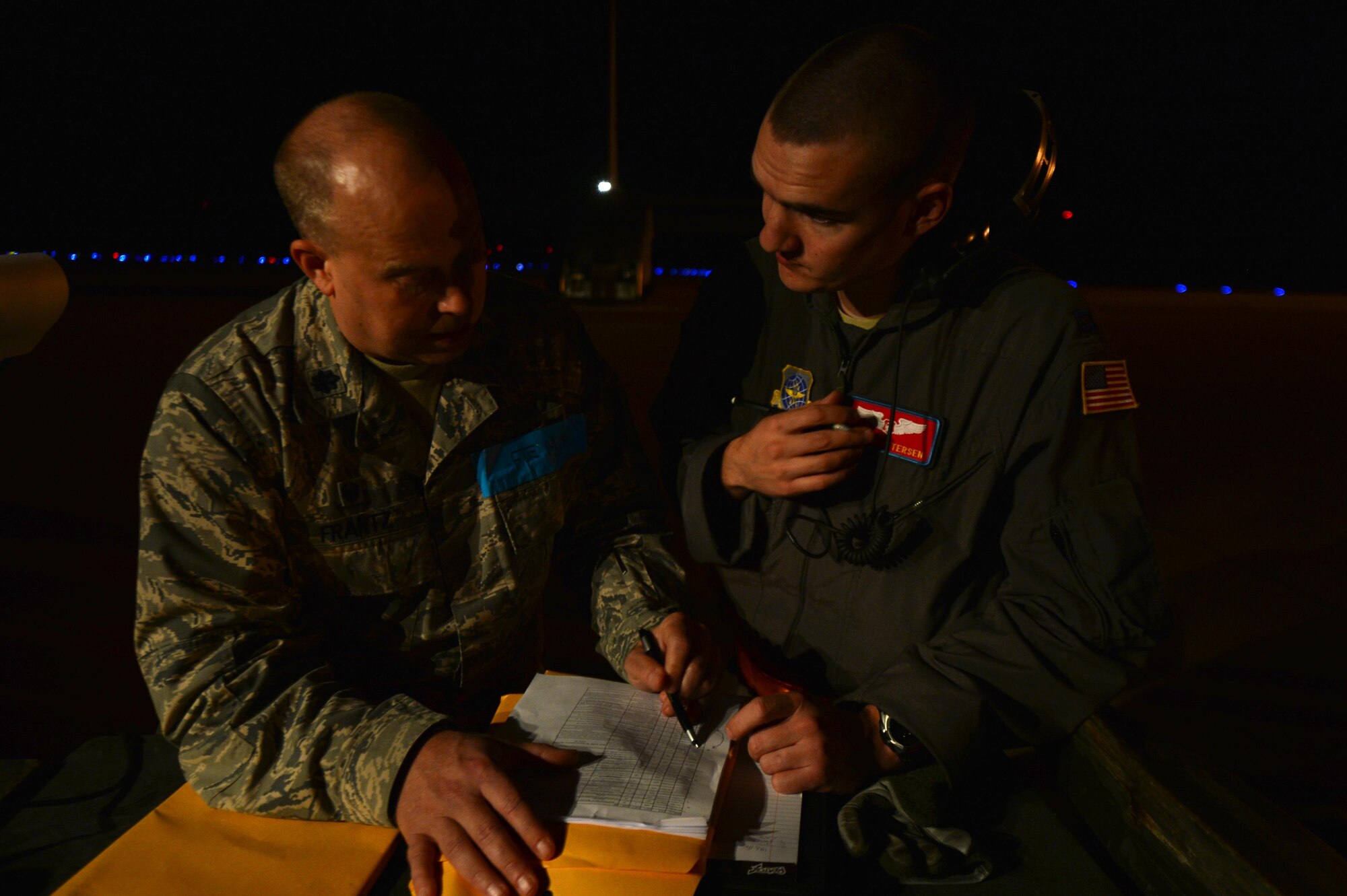 (From left) U.S. Air Force Lt. Col. Russ Frantz, 375th Aeromedical Squadron commander, acts as a federal emergency management agency member to brief U.S. Air Force Capt. Jordan Petersen, 375th Aeromedical Evacuation Squadron flight nurse, on patient care and procedures during exercise Tropical Storm Greg, Nov. 8, 2016, at Alexandria, Louisiana. The 375th AES team members created plans for transporting patients and their specific needs.  (U.S. Air Force photo by Airman Grace Nichols)