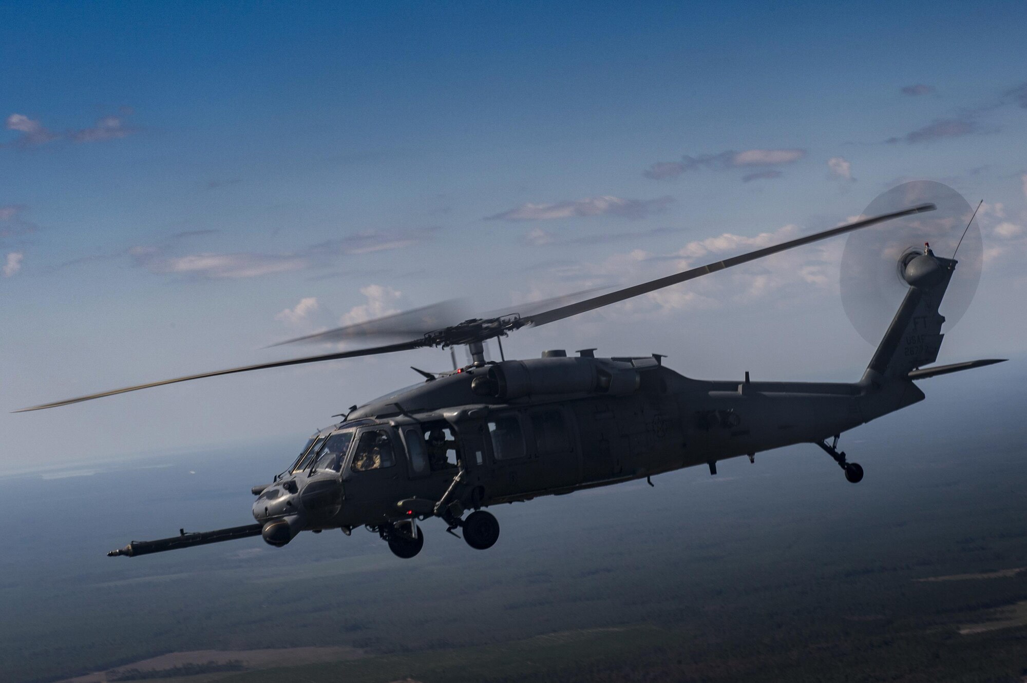 An HH-60G Pave Hawk from the 41st Rescue Squadron flies through the air during a rapid-rescue exercise, Nov. 3, 2016, near Tyndall Air Force Base, Fla. The exercise was designed to test the 347th Rescue Group’s ability to rapidly deploy, plan and execute rescue operations in combat environments. The exercise included HC-130J Combat King IIs, HH-60G Pave Hawks, C-17 Globemaster IIIs, A-10C Thunderbolt IIs, E-8C Joint Stars, pararescuemen and maintenance, intelligence and support personnel. (U.S. Air Force photo by Tech. Sgt. Zachary Wolf)