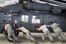 Airmen from the 41st Helicopter Maintenance Unit and the 325th Logistics Readiness Squadron unload an HH-60G Pave Hawk, assigned to the 41st Rescue Squadron, from a C-17 Globemaster III, during a rapid-rescue exercise, Nov. 1, 2016, at Tyndall Air Force Base, Fla. The first stage of the exercise tested Moody’s ability to quickly deploy rescue aircraft and personnel to an austere environment. (U.S. Air Force photo by Staff Sgt. Ryan Callaghan)
