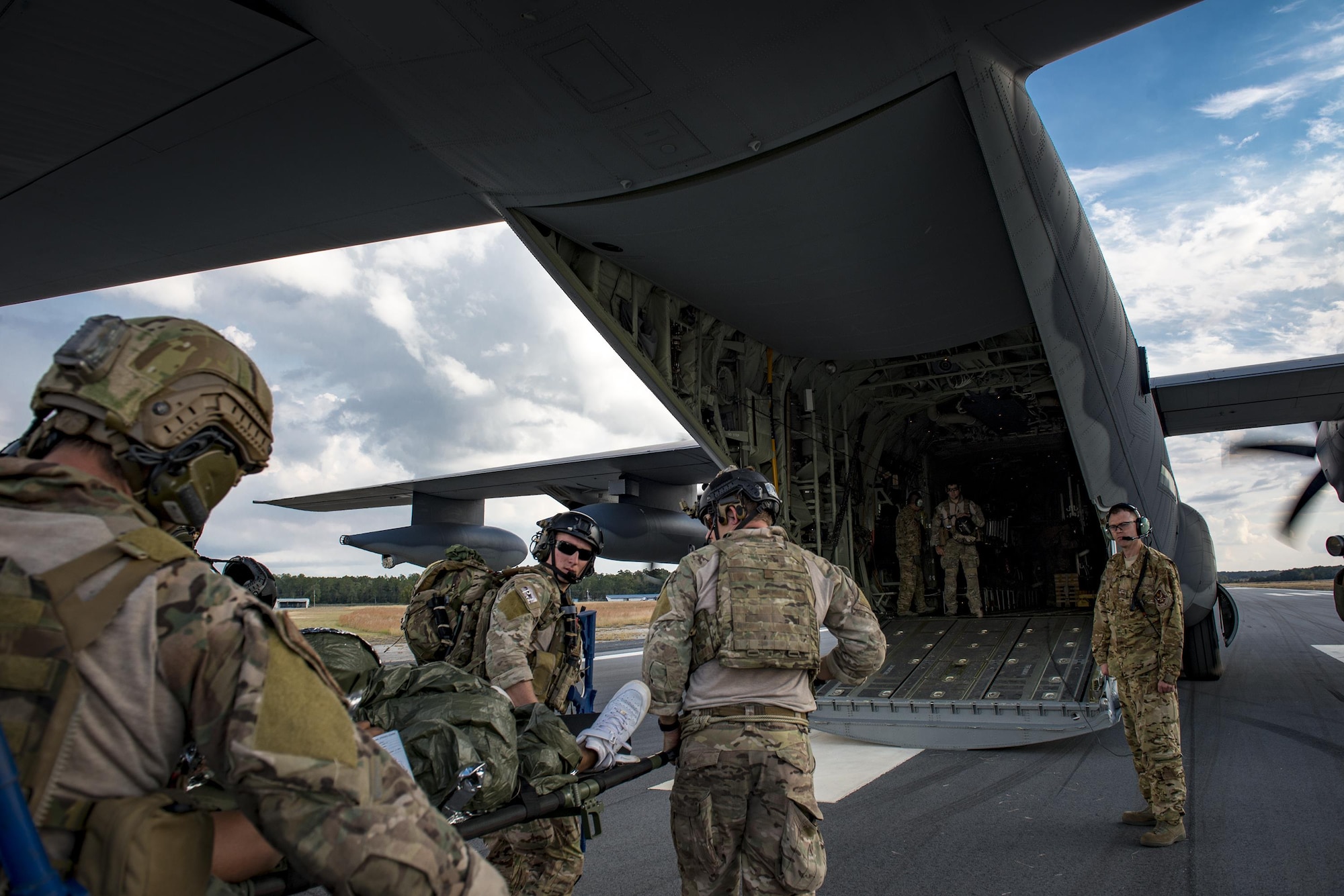 Pararescuemen from the 38th Rescue Squadron load a patient into an HC-130J Combat King II during a rapid-rescue exercise, Nov. 2, 2016, in Mariana, Fla. The exercise was designed to test the 347th Rescue Group’s ability to rapidly deploy, plan and execute rescue operations in combat environments. The exercise included HC-130J Combat King IIs, HH-60G Pave Hawks, C-17 Globemaster IIIs, A-10C Thunderbolt IIs, E-8C Joint Stars, pararescuemen and maintenance, intelligence and support personnel. (U.S. Air Force photo by Staff Sgt. Ryan Callaghan)
