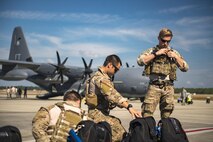 Pararescuemen from the 38th Rescue Squadron don parachutes prior to a freefall jump from an HC-130J Combat King II during a rapid-rescue exercise, Nov. 2, 2016, at Tyndall Air Force Base, Fla. The exercise was designed to test the 347th Rescue Group’s ability to rapidly deploy, plan and execute rescue operations in combat environments. The exercise included HC-130J Combat King IIs, HH-60G Pave Hawks, C-17 Globemaster IIIs, A-10C Thunderbolt IIs, E-8C Joint Stars, pararescuemen and maintenance, intelligence and support personnel. (U.S. Air Force photo by Staff Sgt. Ryan Callaghan)
