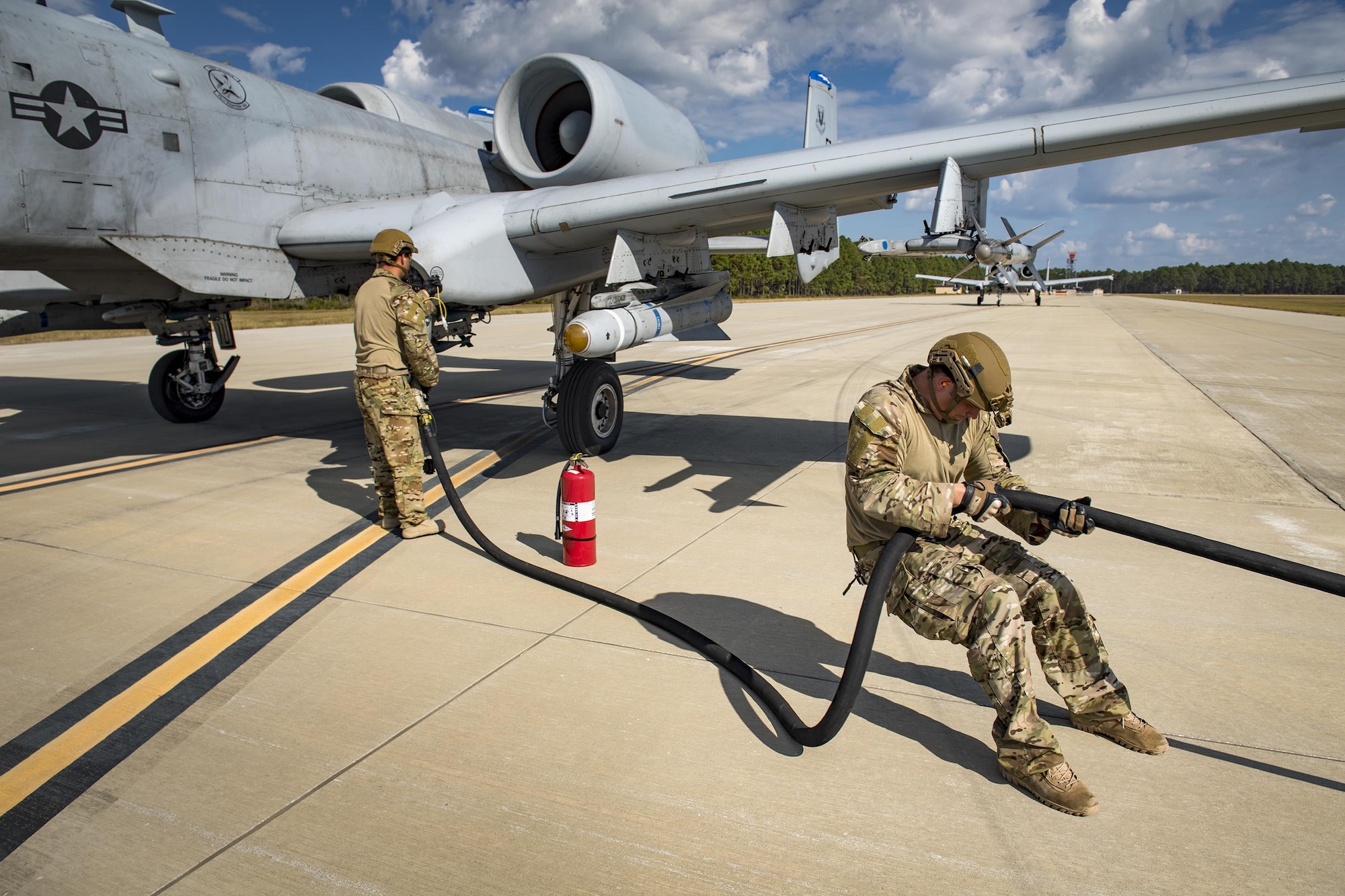 Staff Sgt. Brandon Earl, left, and Staff Sgt. Christopher Dessi, 23d Logistics Readiness Squadron forward area refueling point team members, refuel an A-10C Thunderbolt II, assigned to the 74th Fighter Squadron, during a rapid-rescue exercise, Nov. 3, 2016, at Tyndall Air Force Base, Fla.  Moody’s FARP team is one of only two in Air Combat Command and allows the HC-130J Combat King II to fly into any airfield and refuel aircraft on the ground so they can quickly return to the fight. (U.S. Air Force photo by Staff Sgt. Ryan Callaghan)
