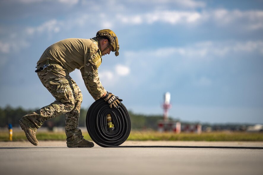Staff Sgt. Christopher Dessi, 23d Logistics Readiness Squadron forward area refueling point team member, rolls up a hose after refueling an A-10C Thunderbolt II aircraft during a rapid-rescue exercise, Nov. 3, 2016, at Tyndall Air Force Base, Fla.  Moody’s FARP team is one of only two in Air Combat Command and allows the HC-130J Combat King II to fly into any airfield and refuel aircraft on the ground so they can quickly return to the fight. (U.S. Air Force photo by Staff Sgt. Ryan Callaghan)
