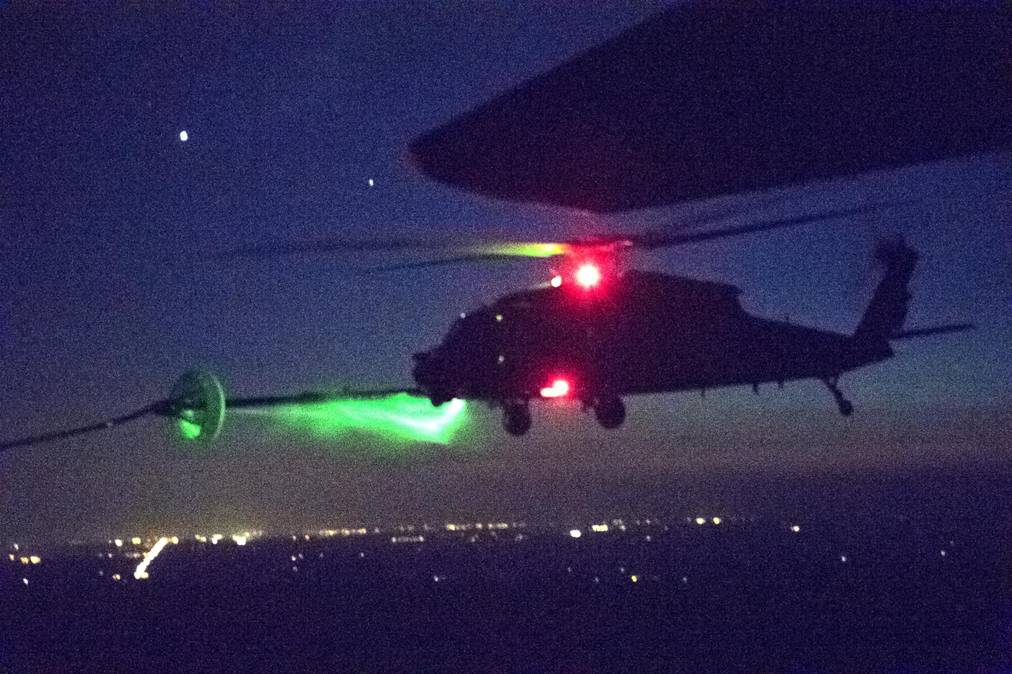 An HH-60G Pave Hawk connects to an HC-130J Combat King II refueling basket during night operations as part of a rapid-rescue exercise, Nov. 3, 2016, near Tyndall Air Force Base, Fla. The exercise was designed to test the 347th Rescue Group’s ability to rapidly deploy, plan and execute rescue operations in combat environments. The exercise included HC-130J Combat King IIs, HH-60G Pave Hawks, C-17 Globemaster IIIs, A-10C Thunderbolt IIs, E-8C Joint Stars, pararescuemen and maintenance, intelligence and support personnel. (U.S. Air Force photo by Staff Sgt. Ryan Callaghan)
