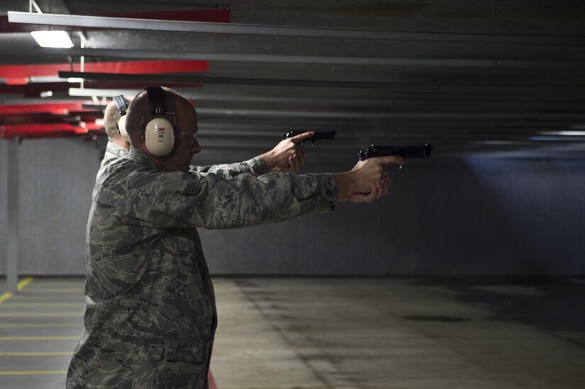 Col. E. John Teichert, 11th Wing and Joint Base Andrews Commander, shoots a Beretta M9 pistol during the 2nd Annual Excellence in Competition at Joint Base Andrews, Md., Nov. 8, 2016. Service members were broken into relays to allow everyone who signed up the chance to participate and test their marksmanship, with each member shooting 30 rounds from a Beretta M9 pistol. Targets were scored by combat arms instructors, and then compared to determine the best marksman (U.S. Air Force photo by Senior Airman Mariah Haddenham)