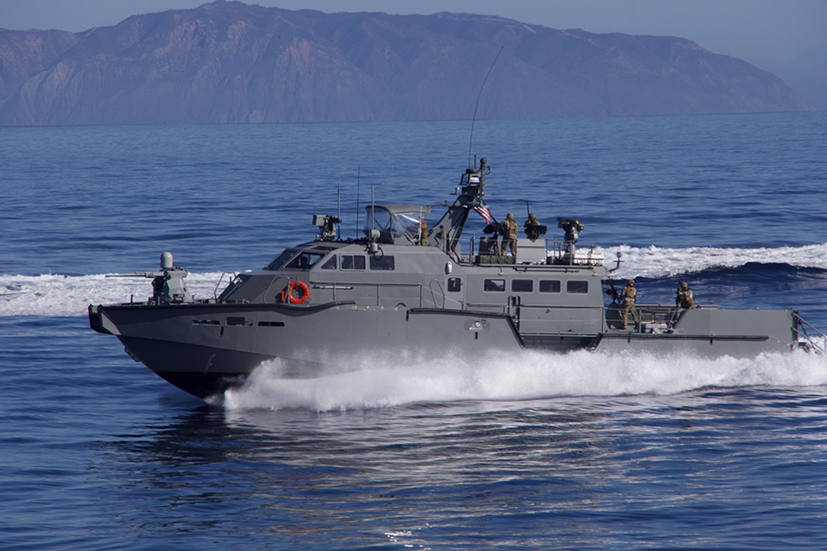 A U.S. Navy Mark VI patrol boat wards off a simulated attacker during show of force strait transit exercise involving aircraft carrier USS Carl Vinson and Carrier Strike Group 1, Nov. 4, 2016.  