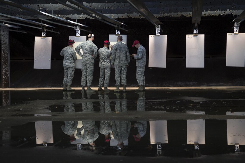 Service members at Joint Base Andrews, Md., check their targets during the 2nd Annual Excellence in Competition, Nov. 8, 2016. Service members were broken into relays to allow everyone who signed up the chance to participate and test their marksmanship, with each member shooting 30 rounds from a Beretta M9 pistol. Targets were scored by combat arms instructors, and then compared to determine the best marksman. (U.S. Air Force photo by Senior Airman Mariah Haddenham)