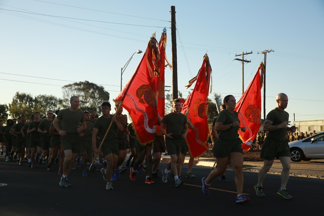 Col. Roberta Shea, commanding officer, I Marine Expeditionary Force Headquarters Group, and Sgt. Maj. David Wilson, sergeant major, I MHG, lead Marines in a motivational run at Marine Corps Base Camp Pendleton, Calif., Nov. 10, 2016. The run was done in celebration of the 241st birthday of the United States Marine Corps. The run is a tradition that is conducted every year prior to the I MEF and I MHG Birthday Ball held later in the evening. (U.S. Marine Corps photo by Pfc. Robert Bliss)
