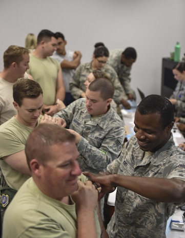 Members of Joint Base Charleston receive their annual flu vaccines from the 628th Medical Group (MDG) at a point of distribution during a public health emergency exercise on Joint Base Charleston, South Carolina, Nov. 9, 2016. In the event of a real world incident, members would be given a flu vaccine if they hadn’t already received one, as well as medication to combat the outbreak. To simulate that, those who participated in the exercise were given the vaccination and candy to represent the medication.