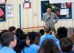 Master Sgt. Joe Ugarte, 802nd Force Support Squadron Military Family Readiness Center Readiness NCO, speaks to students during Operation Flags at Randolph Elementary School May 18, 2016 at Joint Base San Antonio. About 300 third-, fourth- and fifth-graders from Randolph Elementary School accomplished a special "mission" called Operation FLAGS where they experienced what it's like for their active-duty parents to leave for a deployment.