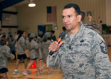 Master Sgt. Joe Ugarte, 802nd Force Support Squadron Military Family Readiness Center Readiness NCO, gives instructions during Operation Flags at Randolph Elementary School May 18, 2016 at Joint Base San Antonio. About 300 third-, fourth- and fifth-graders from Randolph Elementary School accomplished a special "mission" called Operation FLAGS where they experienced what it's like for their active-duty parents to leave for a deployment.
