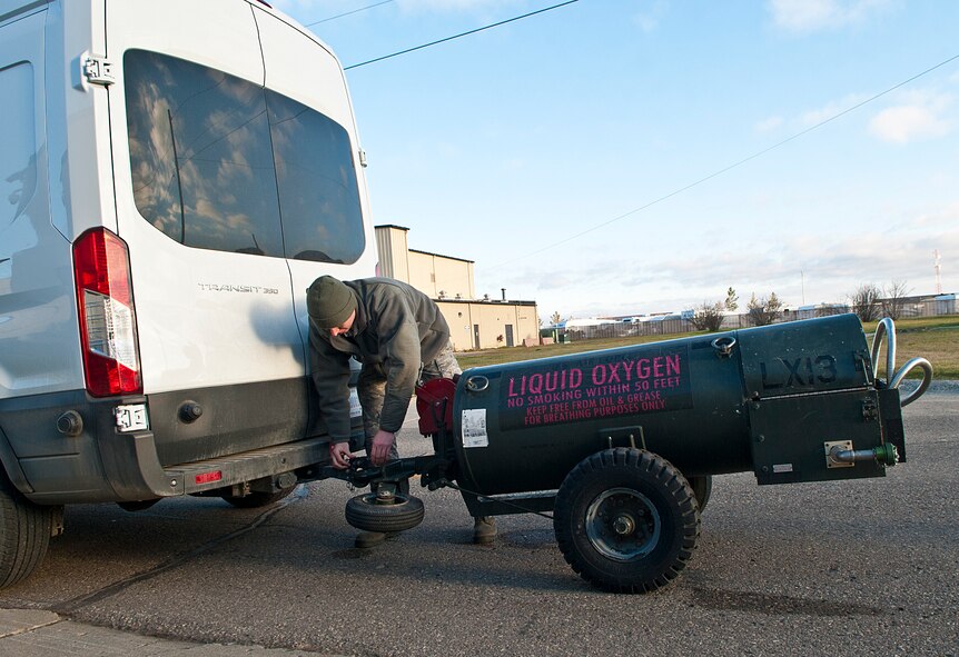 Airman 1st Class Joshua Davis, 5th Maintenance Squadron electrical and environmental apprentice, connects a liquid oxygen cart to a truck at Minot Air Force Base, N.D., Nov. 7, 2016. Electrical and environmental Airmen perform daily inspections on all liquid oxygen carts used for supplying oxygen to aircrews. (U.S. Air Force photo/Airman 1st Class Jonathan McElderry)