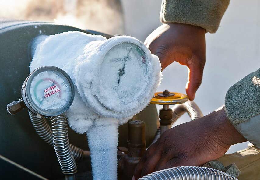 An Airman with the 5th Maintenance Squadron electrical and environmental section relieves pressure from a liquid oxygen cart at Minot Air Force Base, N.D., Nov. 2, 2016.  Electrical and environmental Airmen constantly manage oxygen pressure in the carts, which provide aircrews with oxygen when flying at high altitudes. (U.S. Air Force photo/Airman 1st Class Jonathan McElderry)