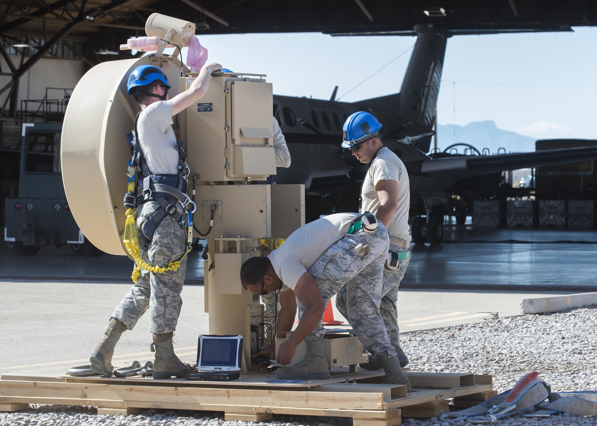 Aircraft communications maintenance Airmen from the 49th Aircraft Maintenance Squadron prepare a Ground Data Terminal antenna to be crane lifted at Holloman Air Force Base, N.M., on Nov. 8, 2016. The GDT is an 800-pound antenna that facilitates communication between Remotely Piloted Aircraft and their crews on the ground in the Ground Control Station. (U.S. Air Force photo by Senior Airman Emily Kenney) 