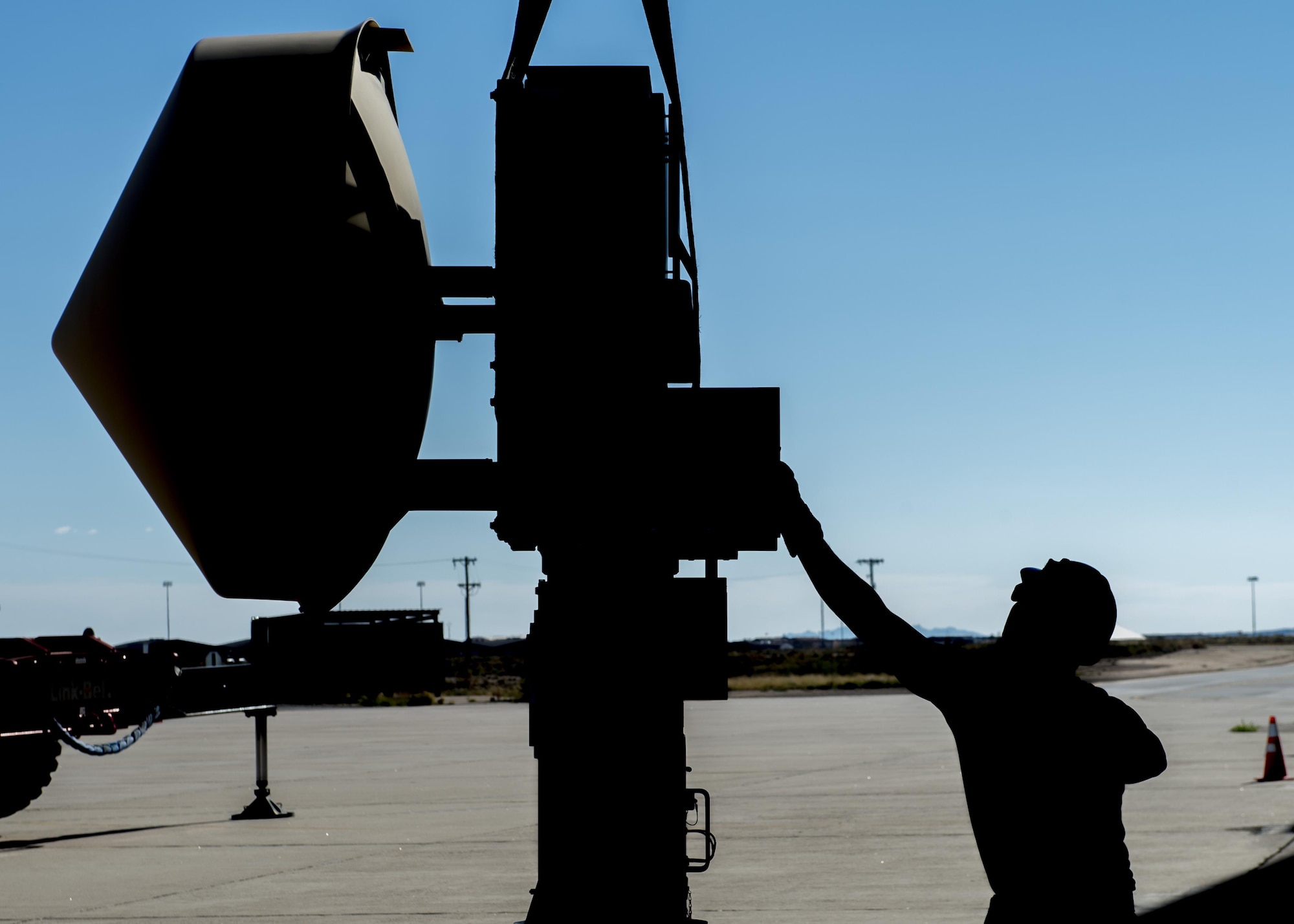 Senior Airman Jon, a 49th Aircraft Maintenance Squadron aircraft communications maintenance technician, balances and guides a Ground Data Terminal antenna into position before installation at Holloman Air Force Base, N.M., on Nov. 8, 2016. The GDT is an 800-pound antenna that facilitates communication between Remotely Piloted Aircraft and their crews on the ground in the Ground Control Station. (U.S. Air Force photo by Senior Airman Emily Kenney)