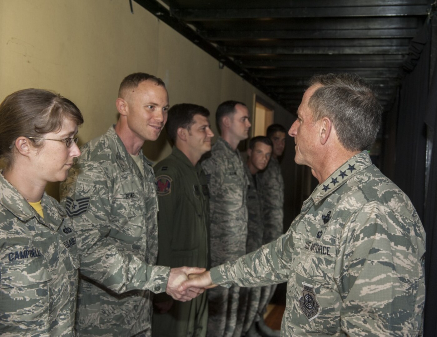 Air Force Chief of Staff Gen. Dave Goldfein congratulates Tech. Sgt. Kyle Rowe, 18th Wing Safety Office occupational safety manager, on outstanding NCO excellence Nov. 4, 2016, at Kadena Air Base, Japan. During his visit, Goldfein congratulated and coined Kadena’s top performers in different units throughout the base. 